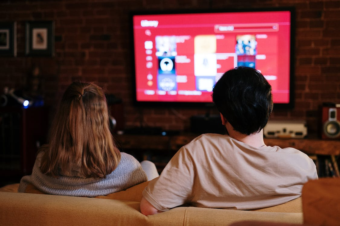 A couple watching television.