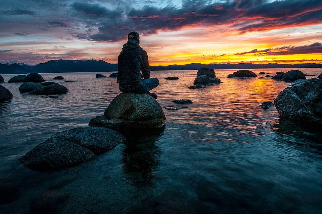 A person relaxing by the water.