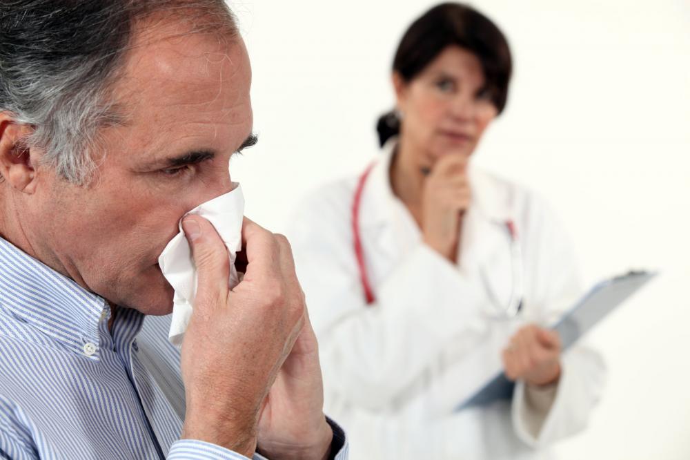 A man sneezing during his appointment with a chiropractor