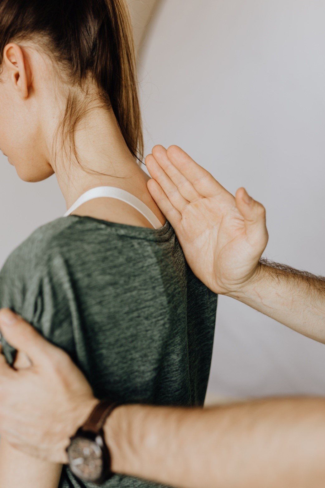 Chiropractor treating neck pain for a female patient