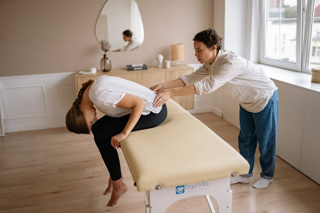 A patient getting lower back pain treatment through chiropractor massage therapy 