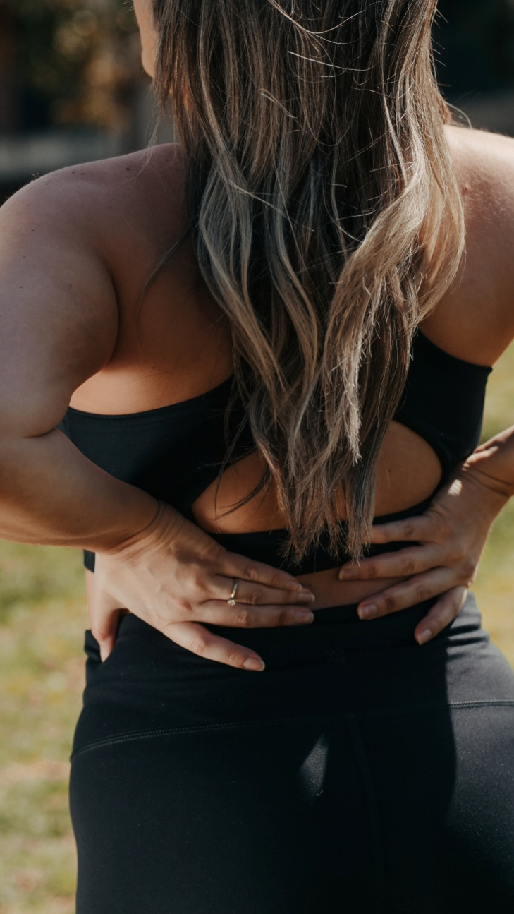 Woman suffering from back pain during exercise