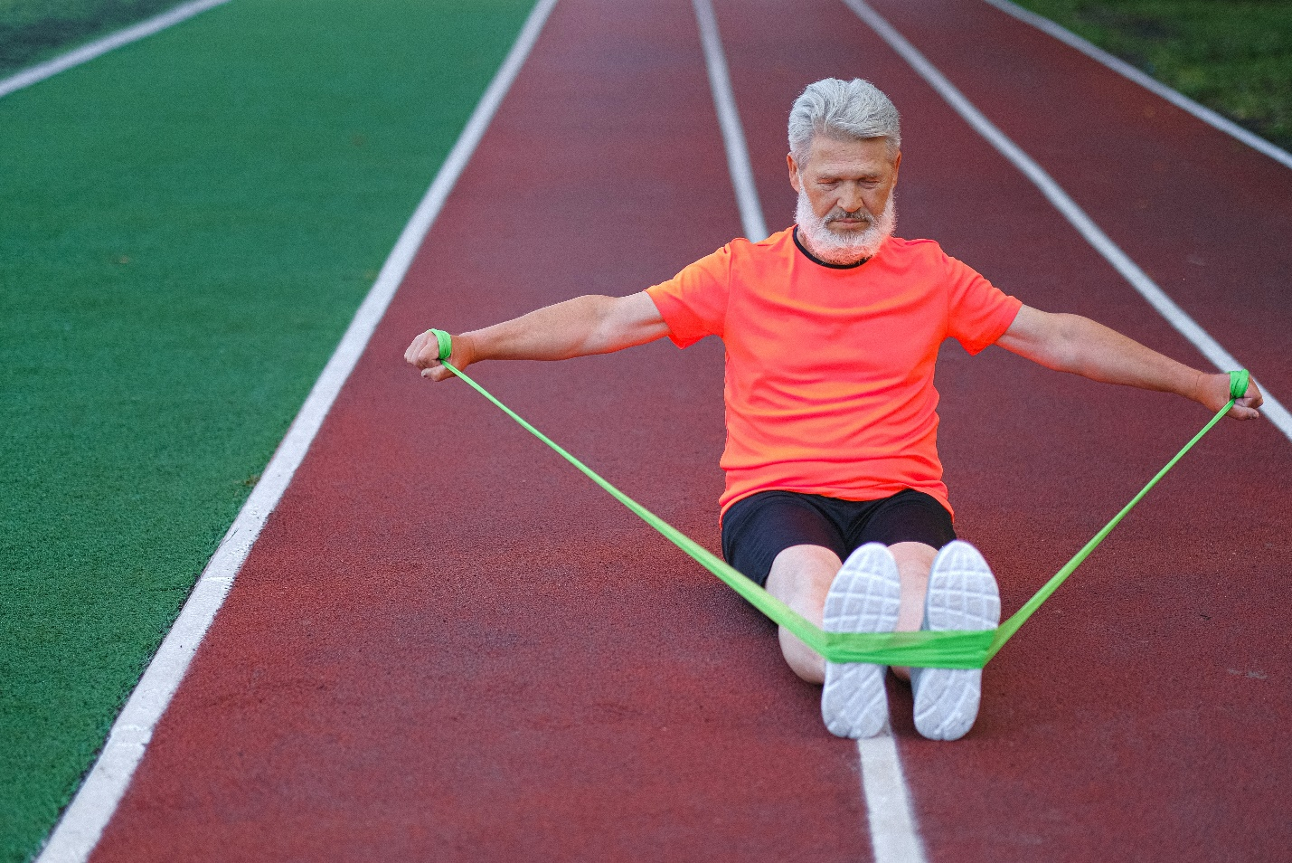 An old man doing exercise with a resistance band