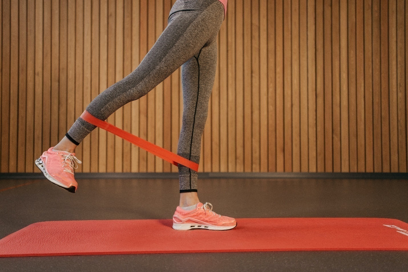 A woman doing leg exercises with a theraband