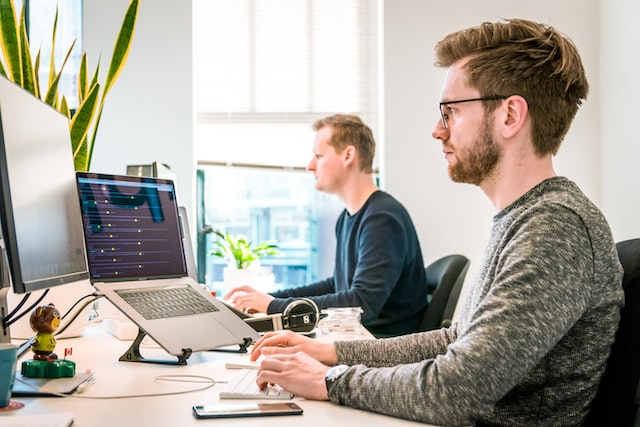 Two men working on their desks