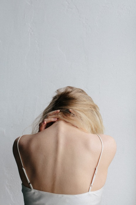 A woman experiencing neck pain.