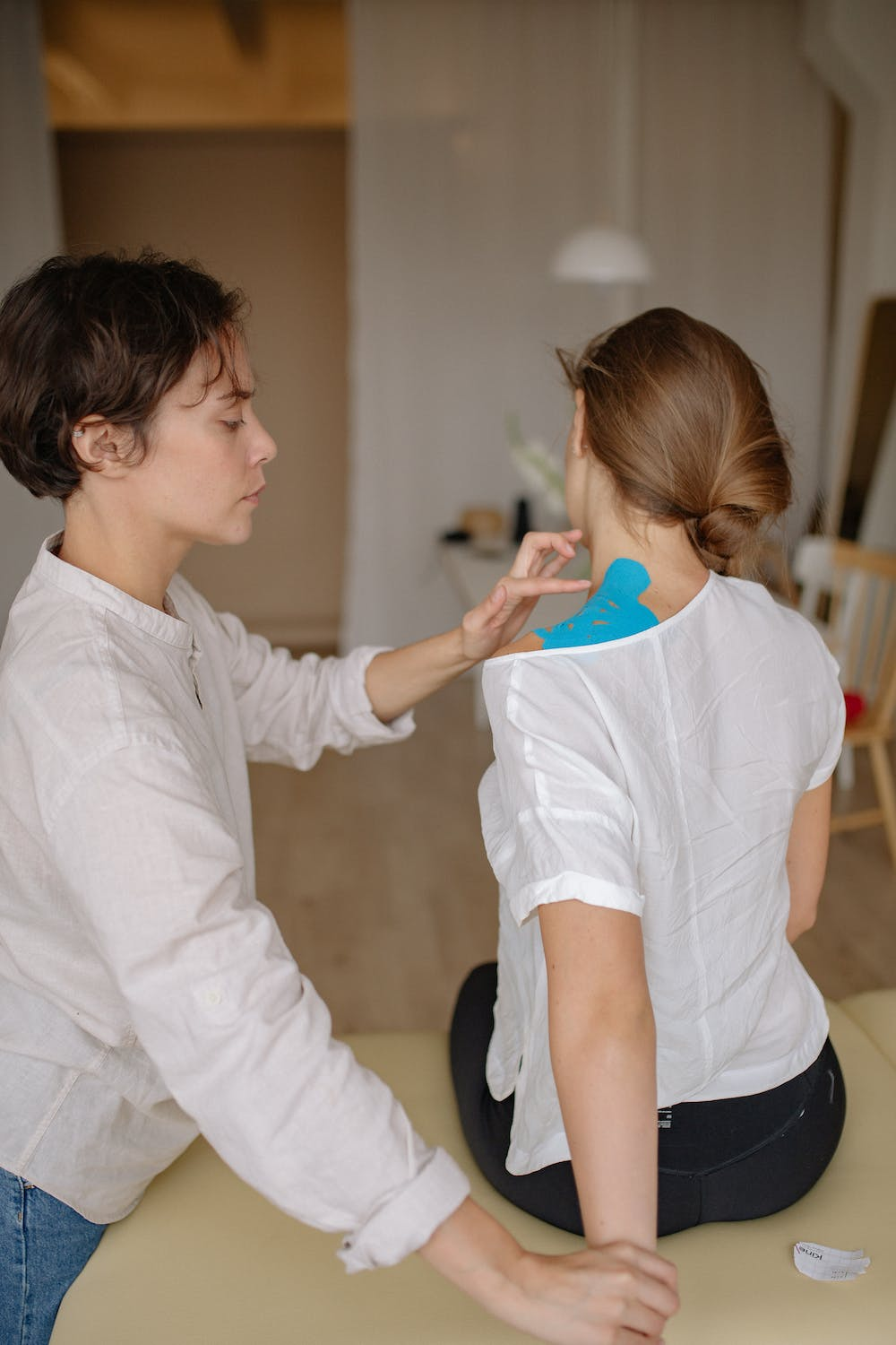 An image of a woman getting a back adjustment from a chiropractor 