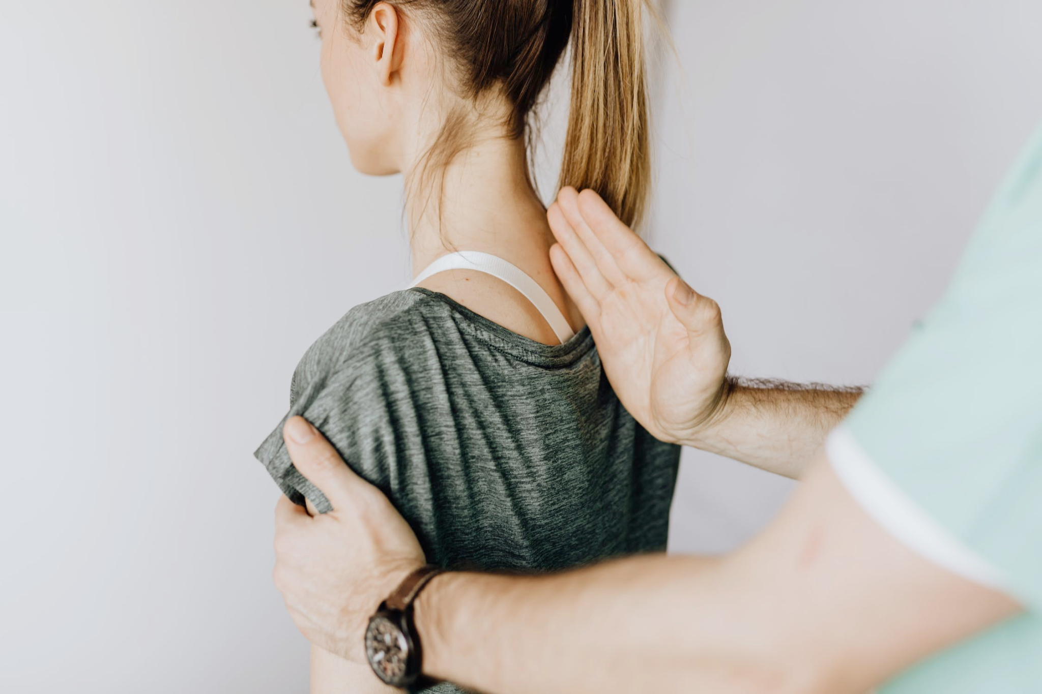 An image of a woman getting a back adjustment from a chiropractor