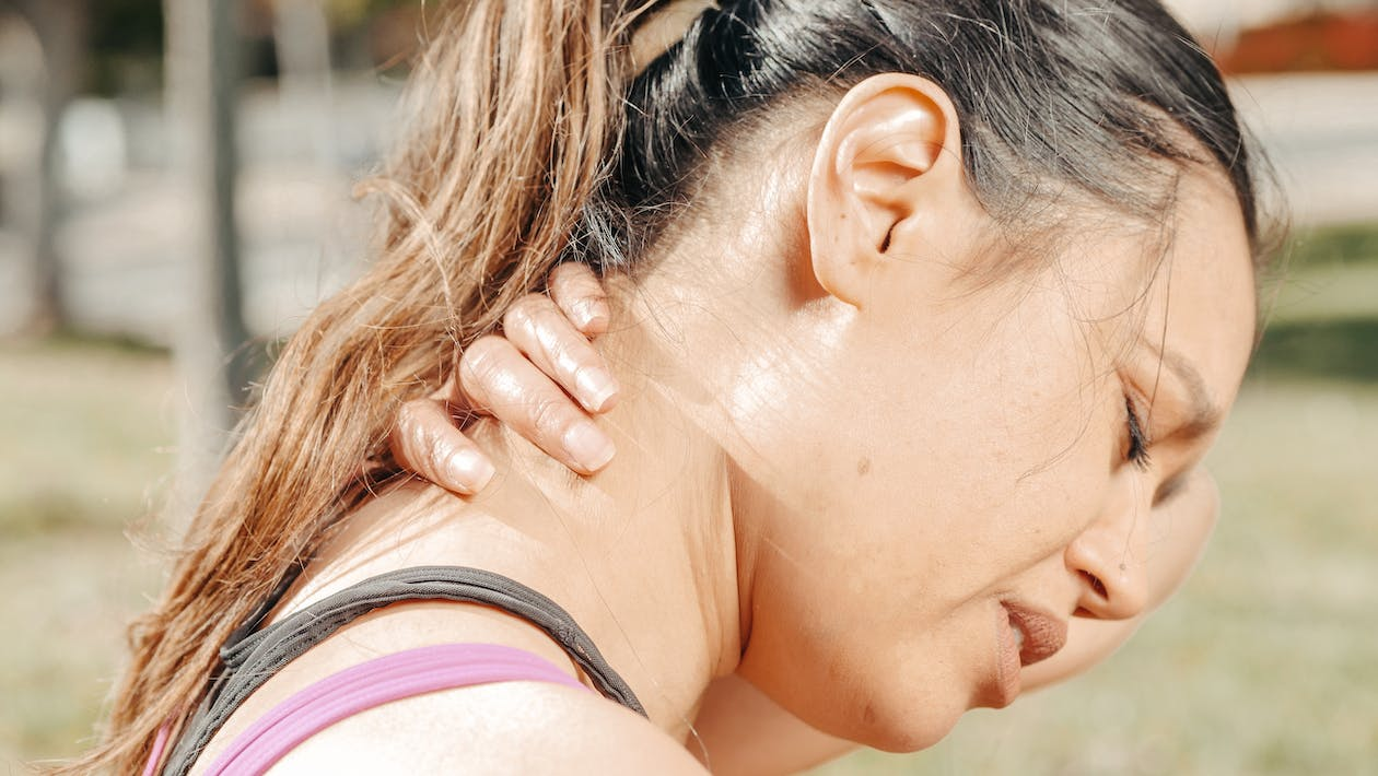 A close-up of a woman having neck pain