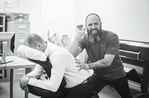 An image of a chiropractor massaging a patient’s back