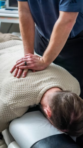 a chiro working on a client’s back