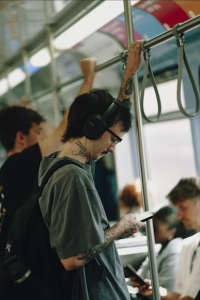 a guy using his phone on a train